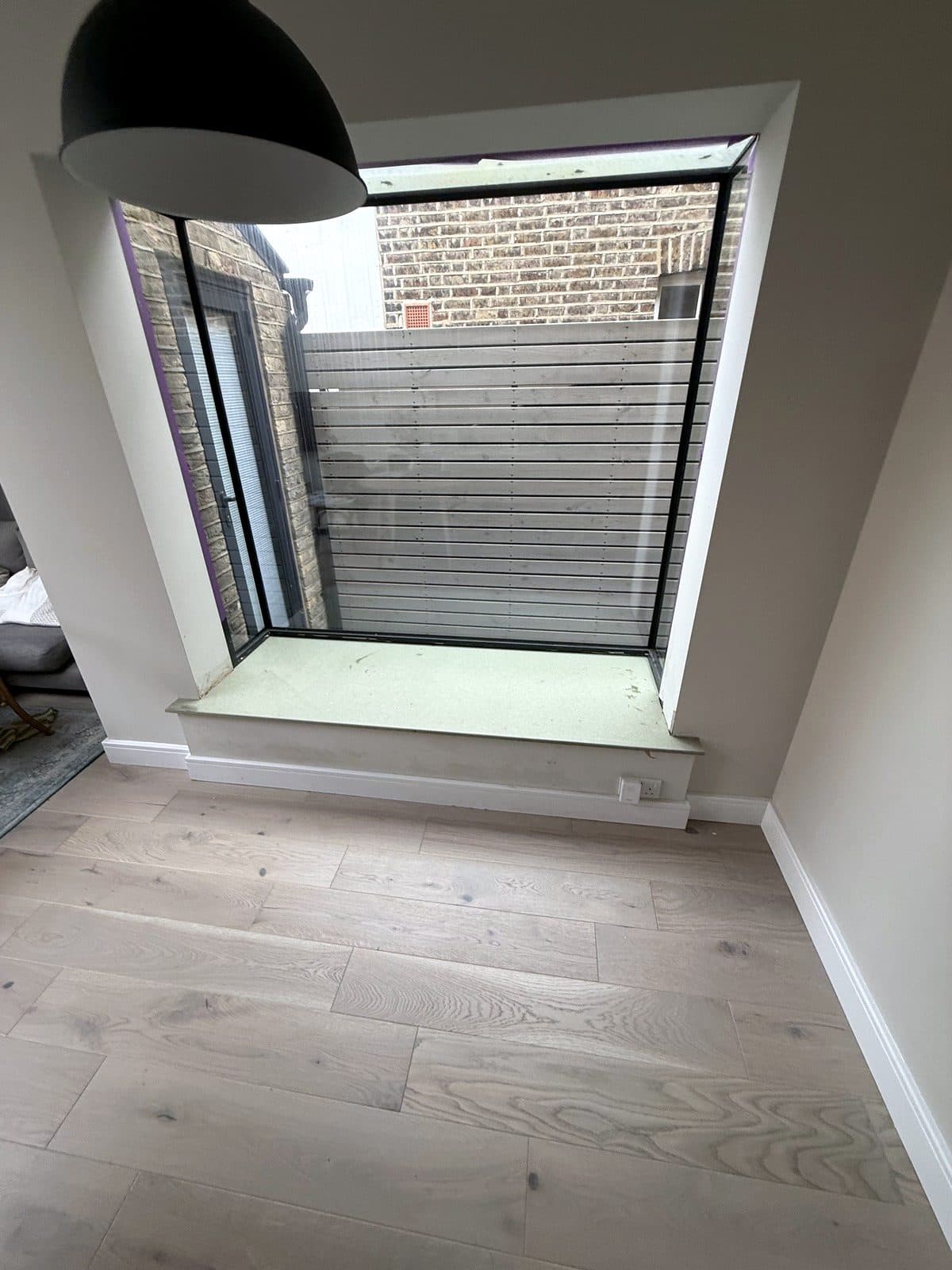 Glass box window with a new grey window seat