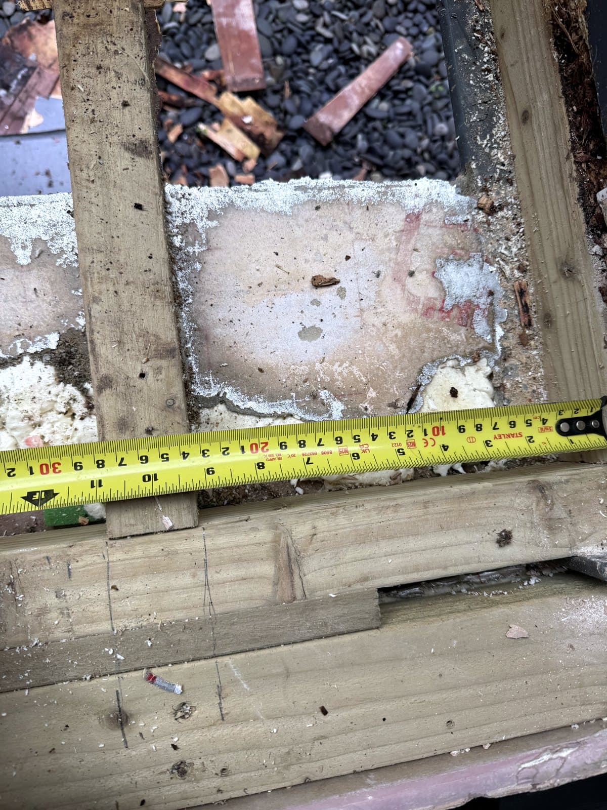 Tape measure across the old timbers of the seat