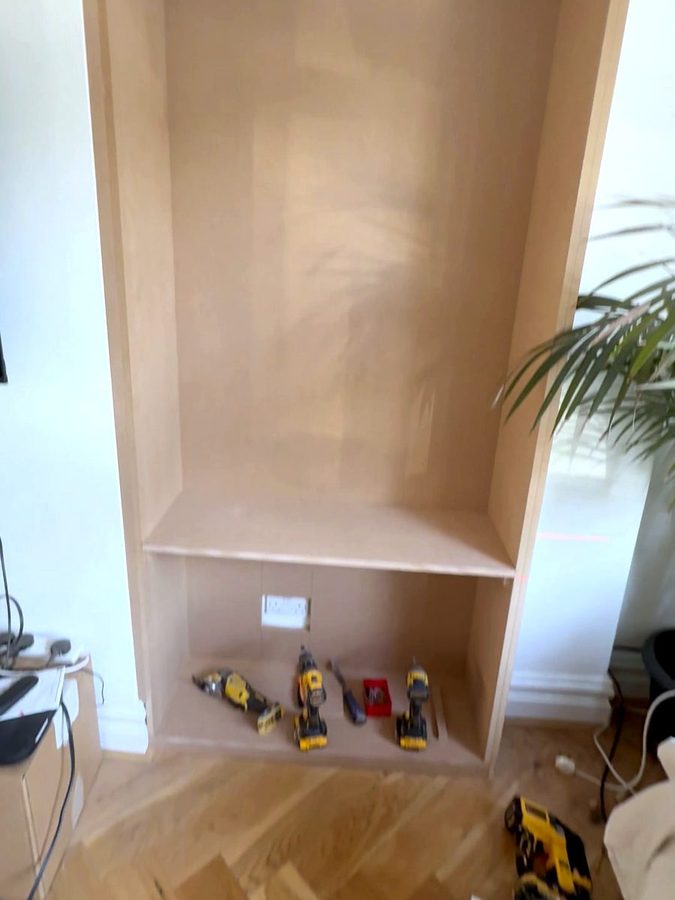 The right alcove lined, with the cupboard top in, a socket below it and tools on the base