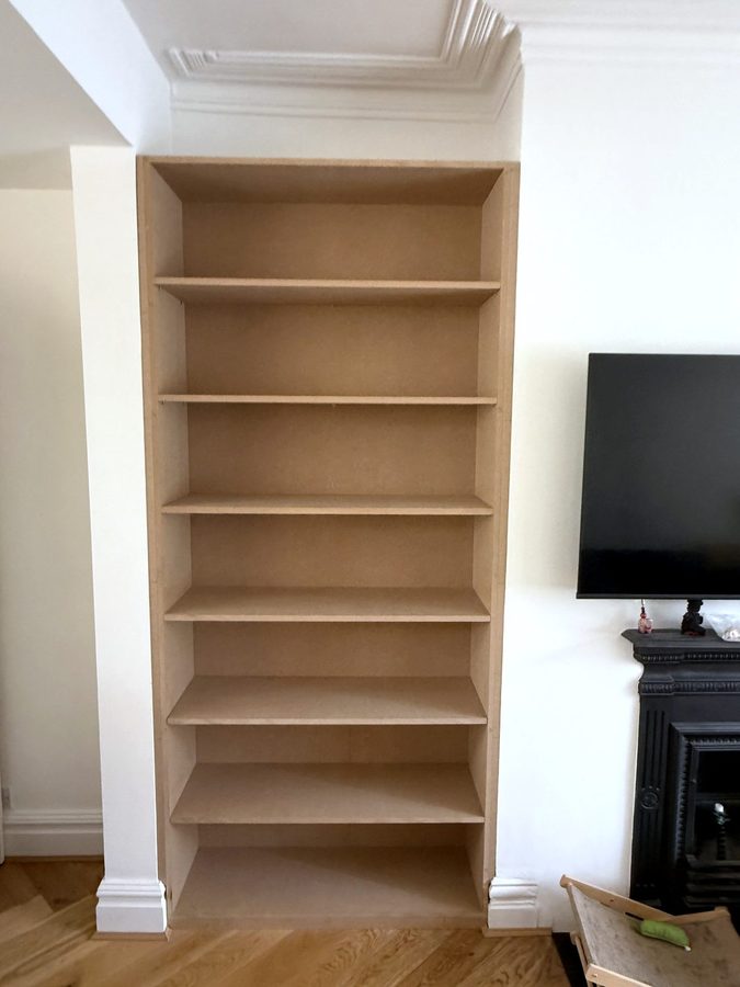 The same alcove with full-height MDF shelves fitted