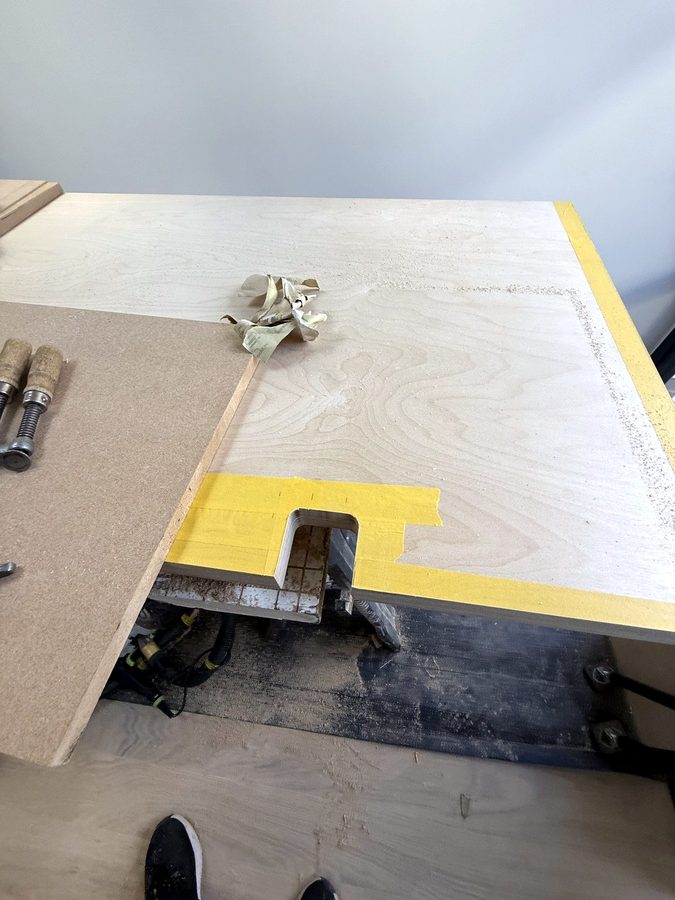 A notch cut into the edge of the top, with masking tape along the cut