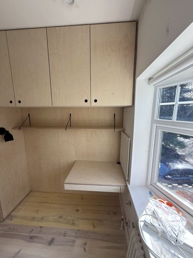 Overhead cupboards and desk going in