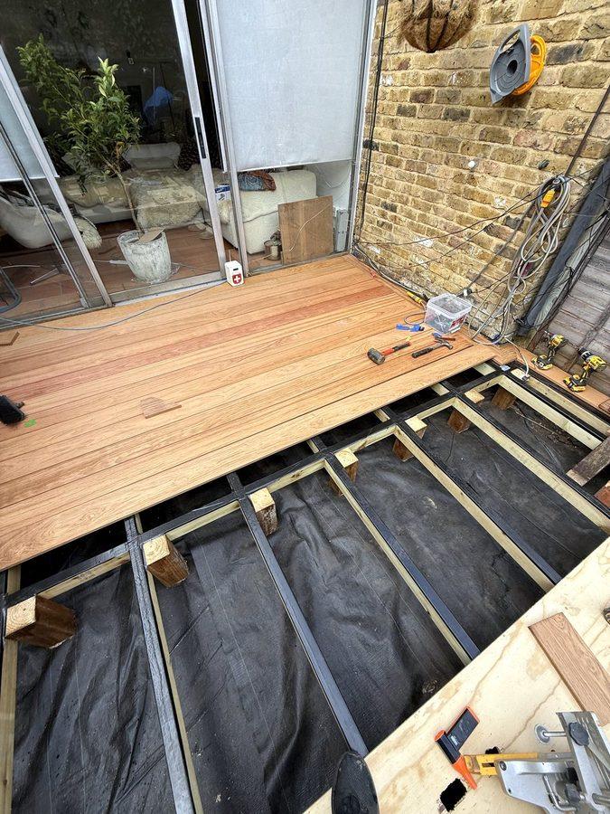 The first boards fixed at the doors, with the black strip on the joists beyond