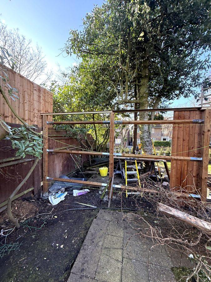 Posts and rails across the garden, with string lines along them