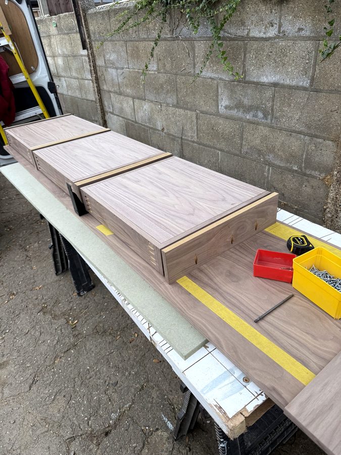The walnut drawer boxes on trestles