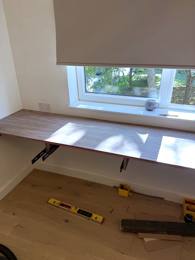 The desk top on, with the drawer runners underneath