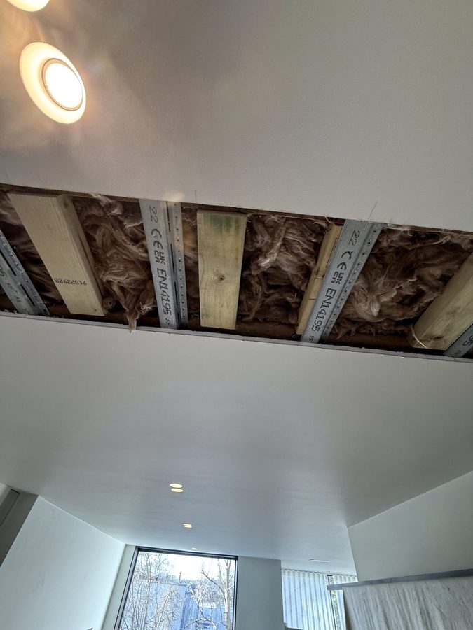 The ceiling opened along the line of the doors, with metal joists and insulation inside