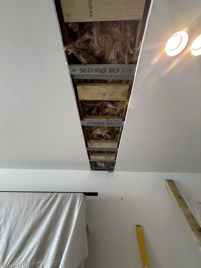 Timber fixed between the metal joists