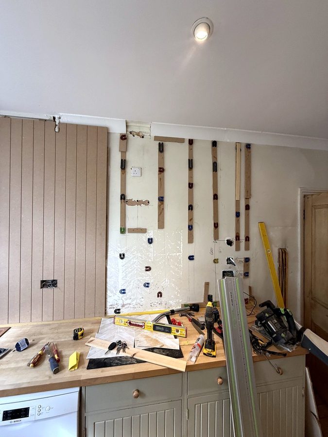 The first V-groove sheet up behind the sink, the track saw and rail on the worktop
