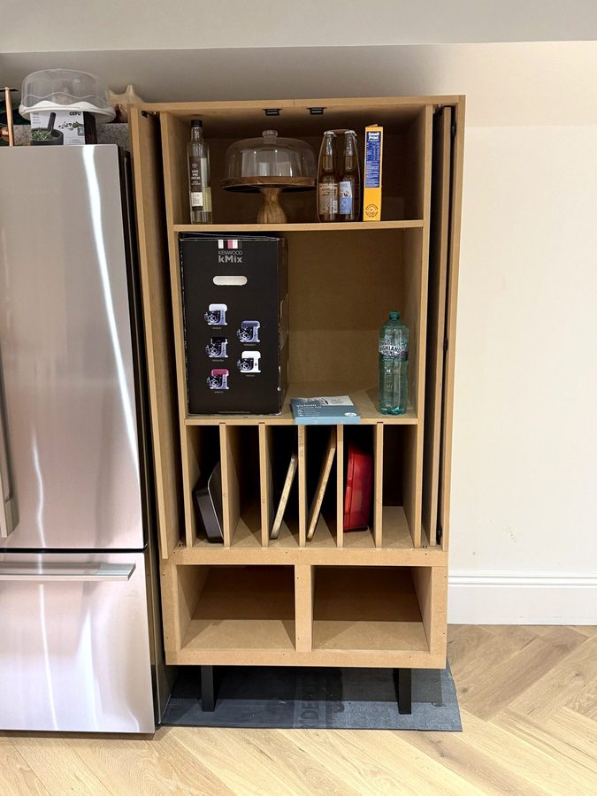 Inside: shelves at the top, upright tray dividers, two cubbies at the bottom