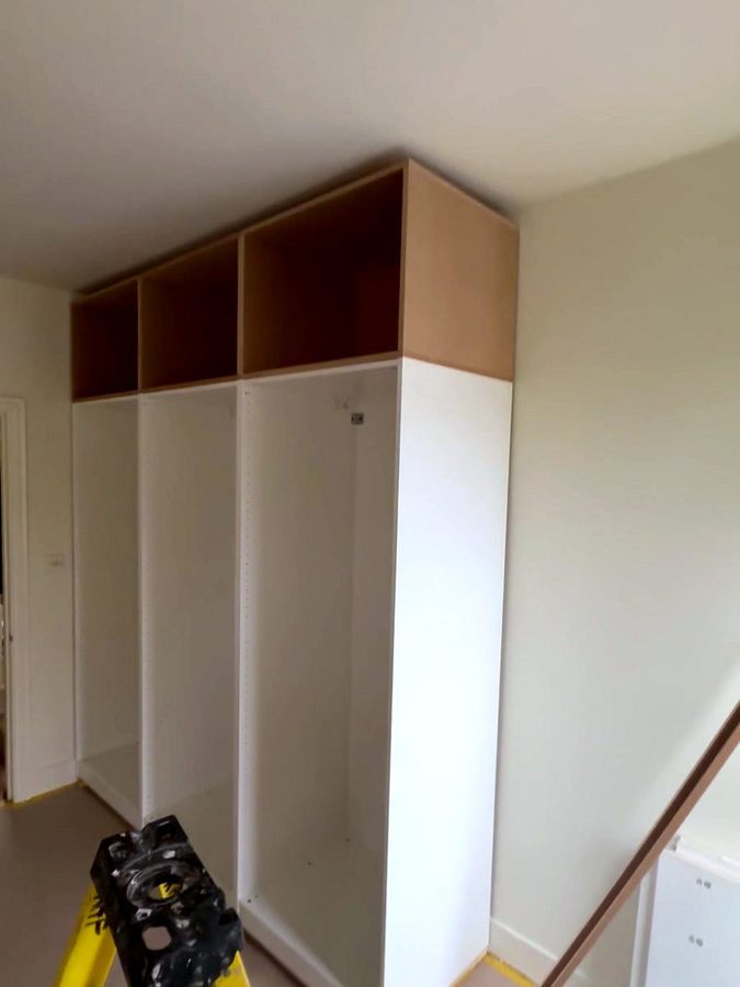 Three white PAX frames against the wall, MDF boxes on top of them