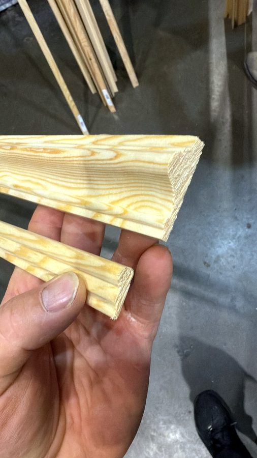 Two pine mouldings in hand: a wide one for the dado rail, a slim one for the frames