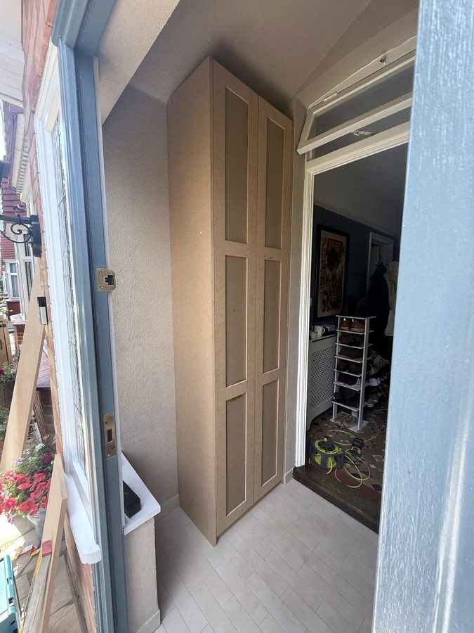 The tall cupboard with its two panelled doors