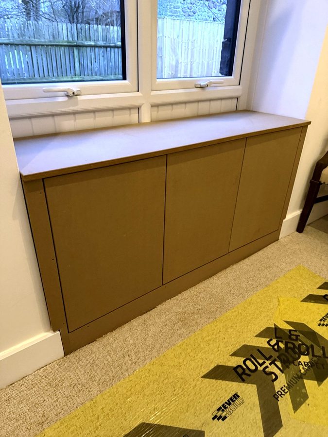 The cupboards under the window with the doors shut