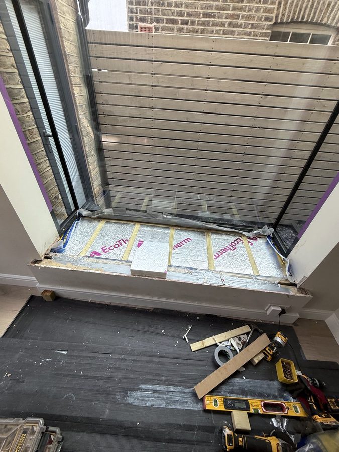 Insulation boards between battens across the seat